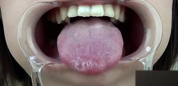  A woman shows her gums and sputs saliva